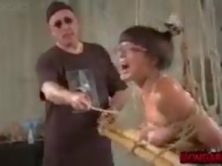 Middle-aged Asian Slave Tortured with Metal Dildo and Tit.